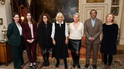 PA Media (left to right) Yael van der Wouden, Rachel Kushner, Anne Michaels, Queen Camilla, Charlotte Wood, Percival Everett, and Samantha Harvey during a reception for the Booker Prize Foundation at Clarence House, London.