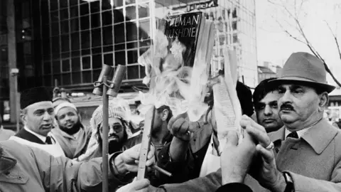 Getty Images Muslims burning copies of Salman Rushdie's novel 'The Satanic Verses' in Bradford, UK, circa 1988.