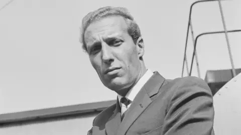 Getty Images Frederick Forsyth is seen in a black and white photo from around the time he was a pilot in his 20s.