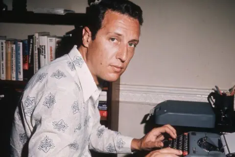 Getty Images Frederick Forsyth in 1970. He is at a typewriter in his study.