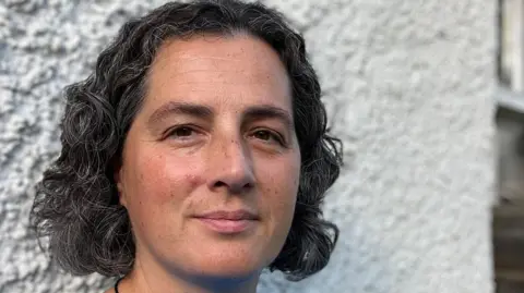 Isla Rosser-Owen A woman with dark hair